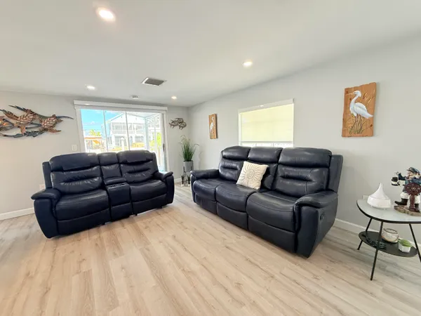 a large kitchen with a table and chairs