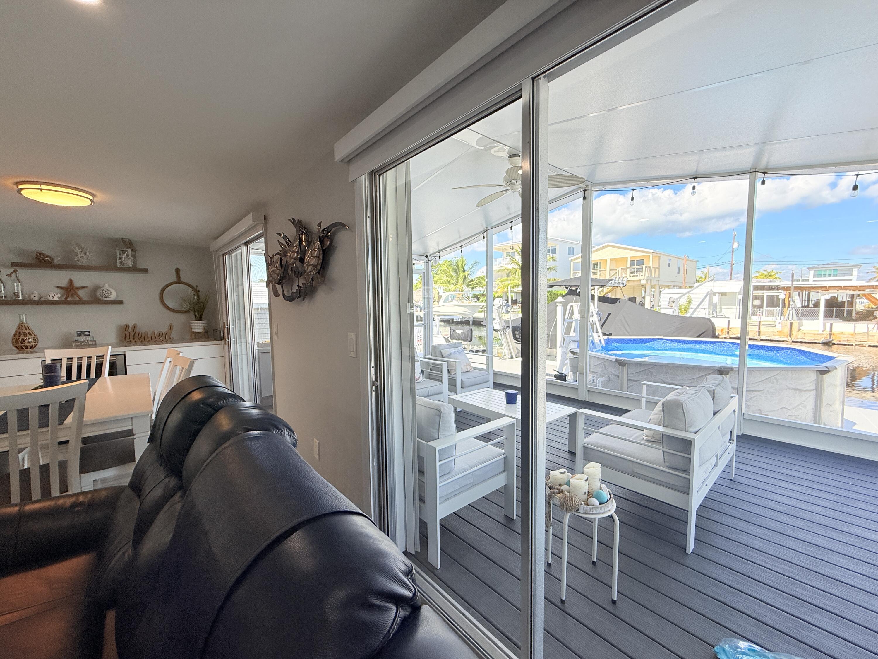 505 Oldsmar Lane Key Largo, FL 33037 - Photo 17 of 61 a living room filled with furniture and a floor to ceiling window