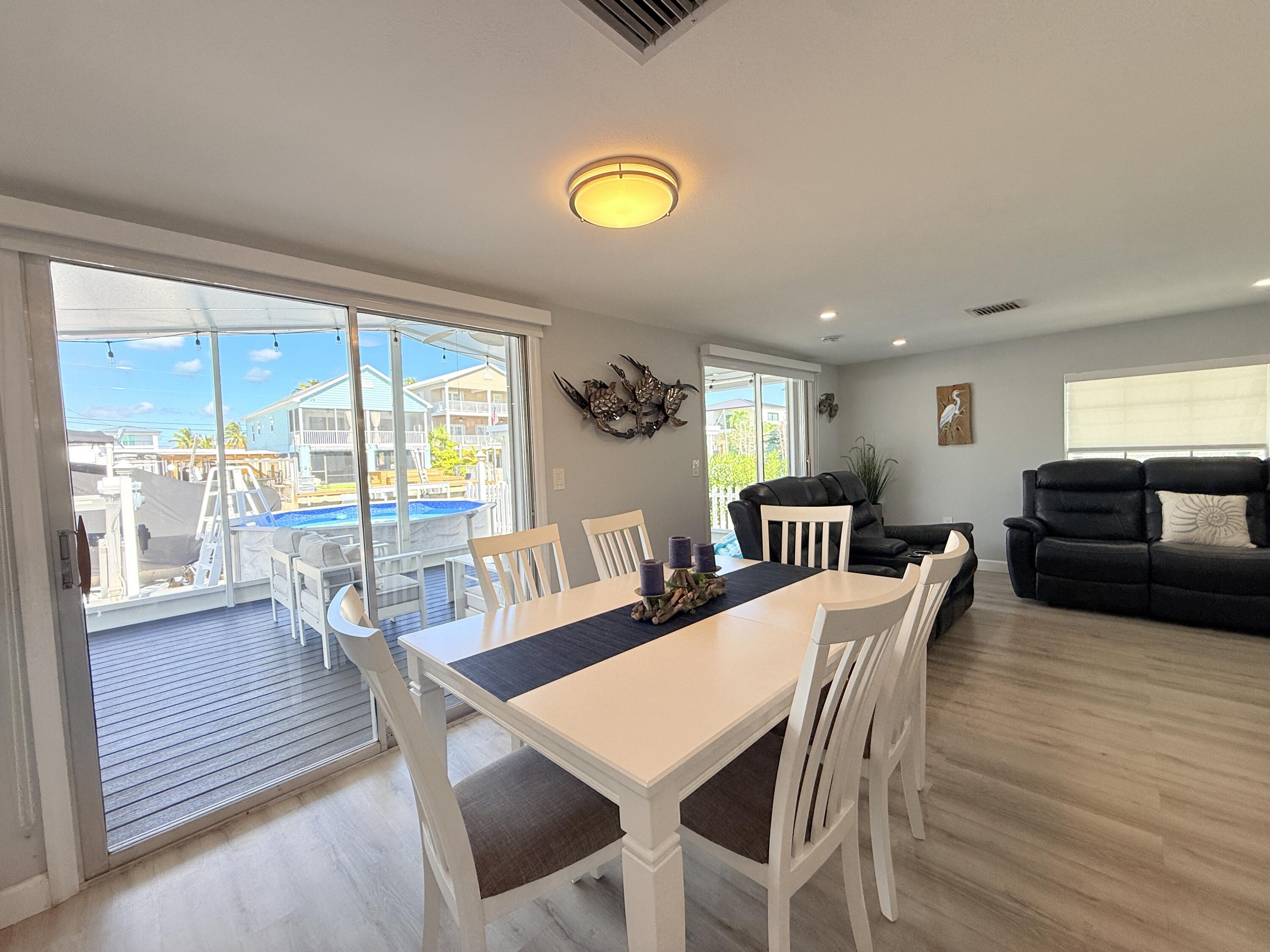 505 Oldsmar Lane Key Largo, FL 33037 - Photo 18 of 61 a view of a dining room with furniture and wooden floor
