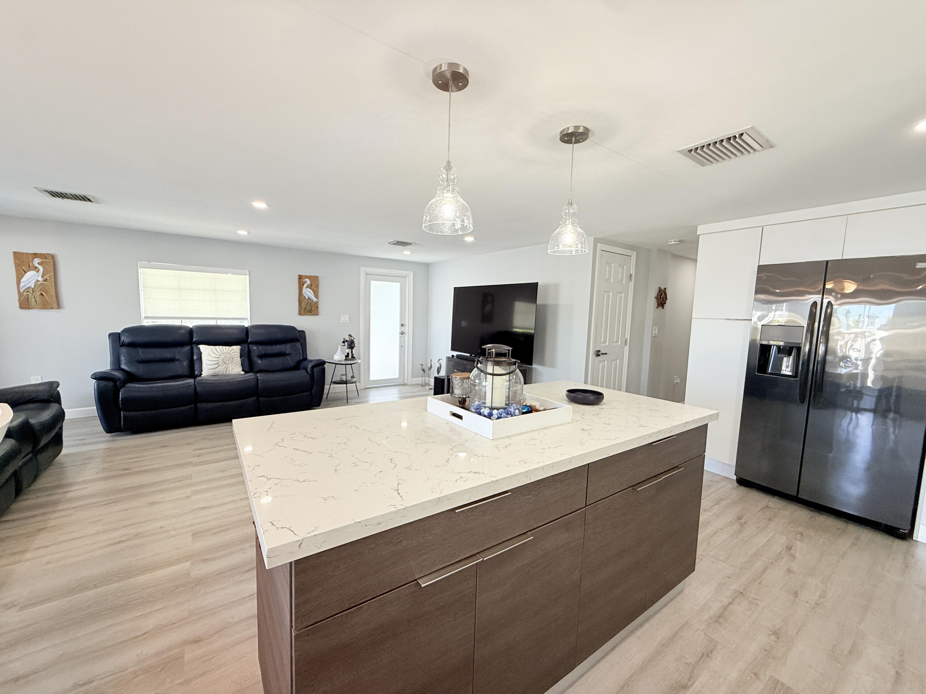 505 Oldsmar Lane Key Largo, FL 33037 - Photo 22 of 61 a large white kitchen with a large counter top appliances and kitchen view