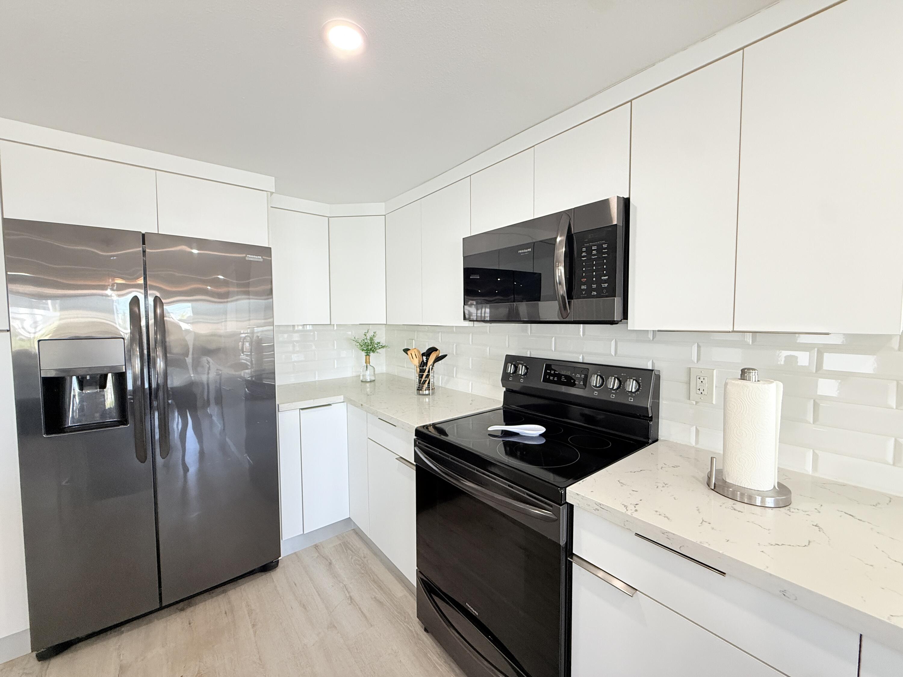 505 Oldsmar Lane Key Largo, FL 33037 - Photo 24 of 61 a kitchen with a refrigerator stove and microwave