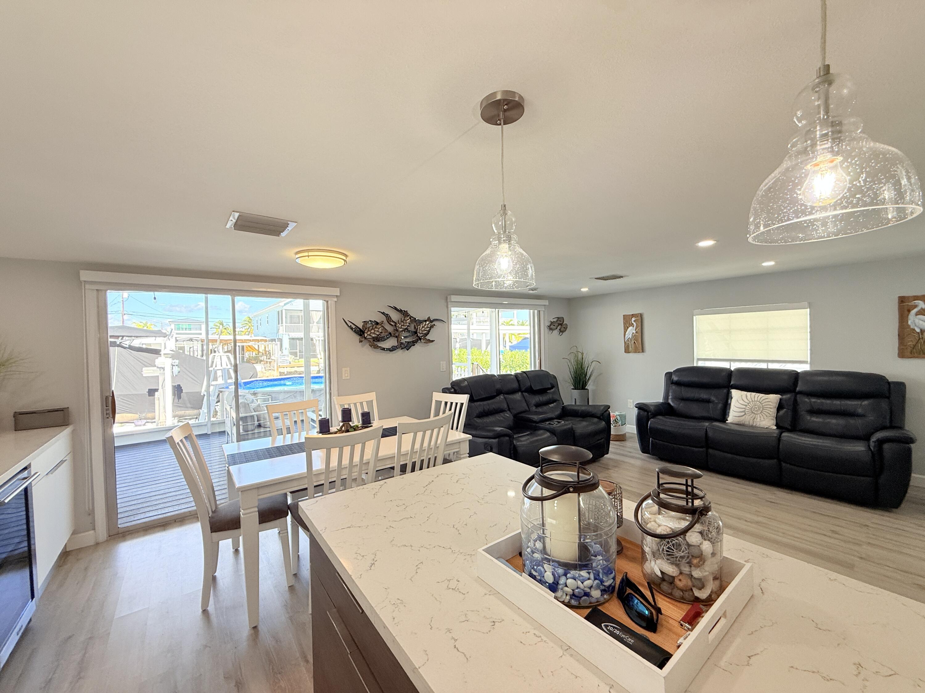 505 Oldsmar Lane Key Largo, FL 33037 - Photo 26 of 61 a living room with furniture a large window and a wooden floor
