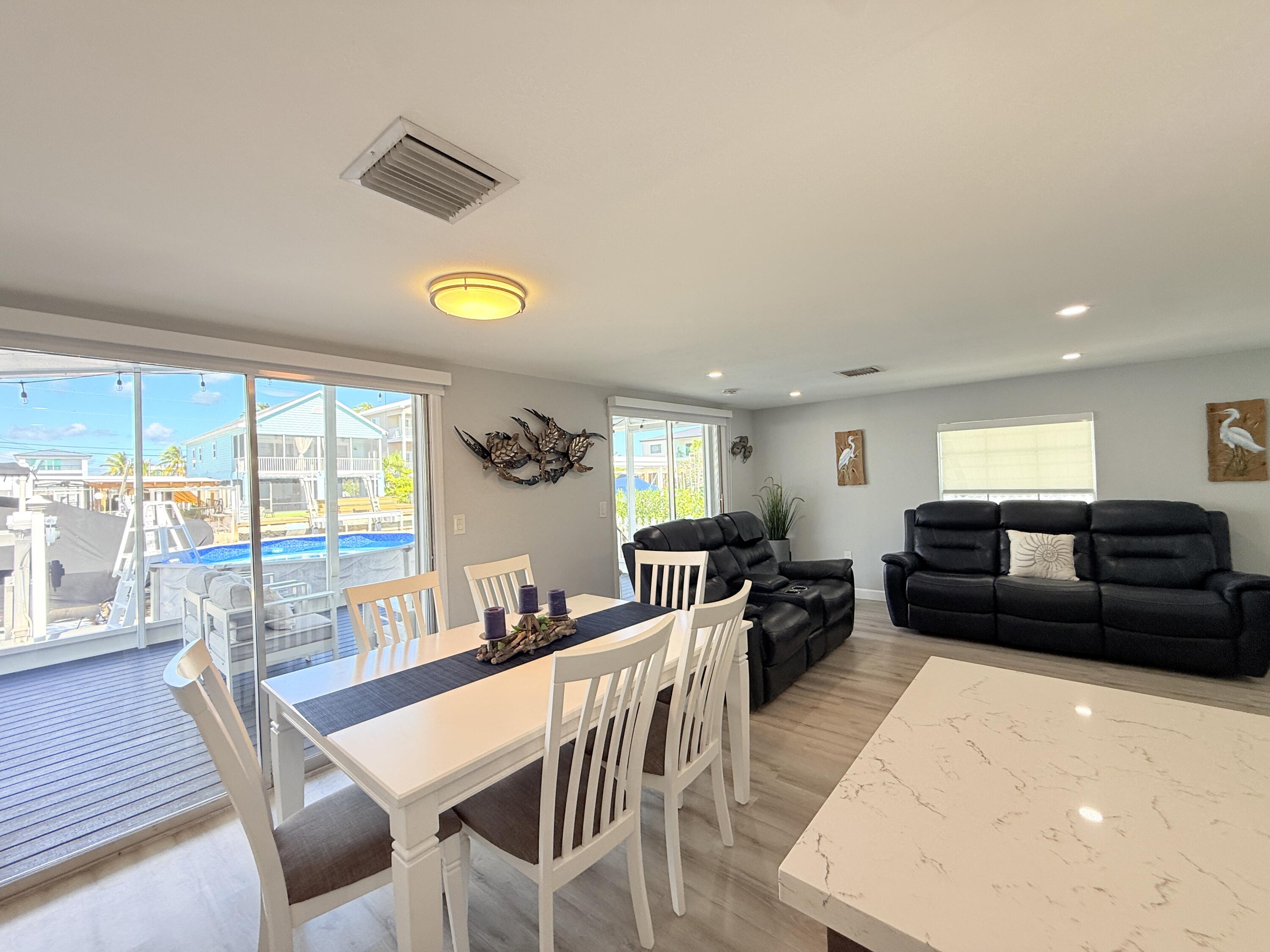 505 Oldsmar Lane Key Largo, FL 33037 - Photo 27 of 61 a living room with furniture and a large window with wooden floor