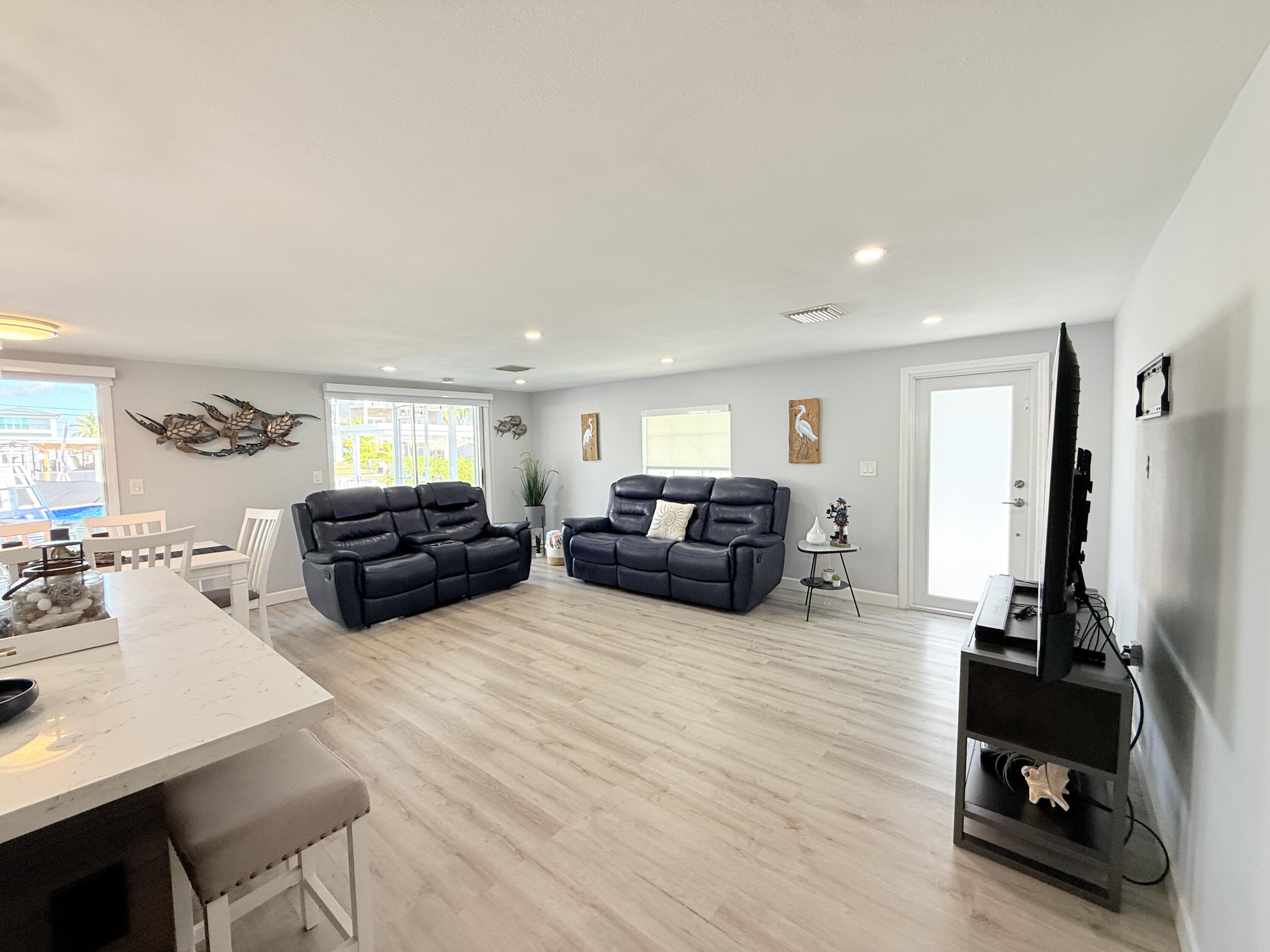 505 Oldsmar Lane Key Largo, FL 33037 - Photo 30 of 58 a living room with furniture a flat screen tv and a window