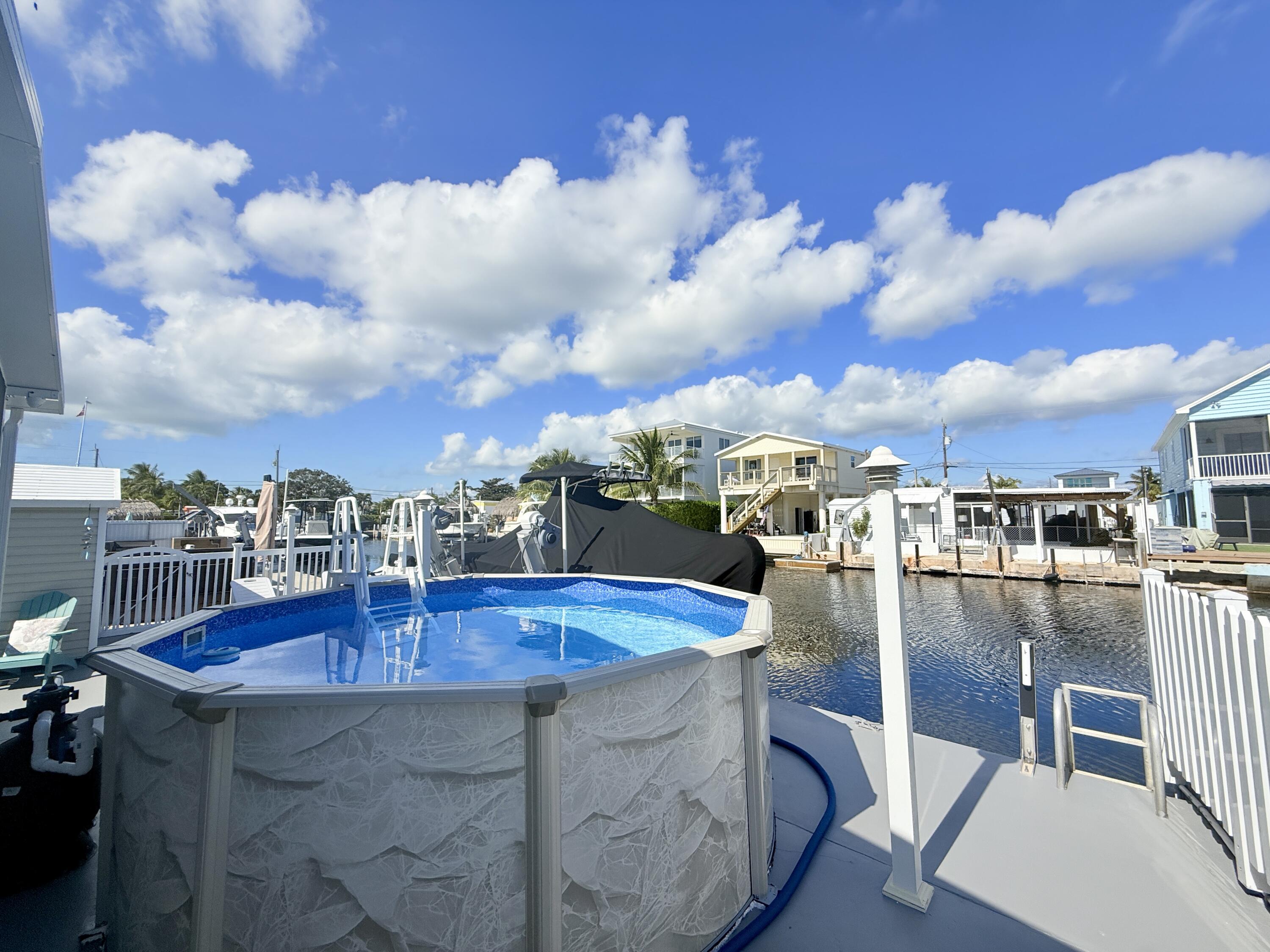 505 Oldsmar Lane Key Largo, FL 33037 - Photo 3 of 61 a view of a swimming pool with outdoor seating