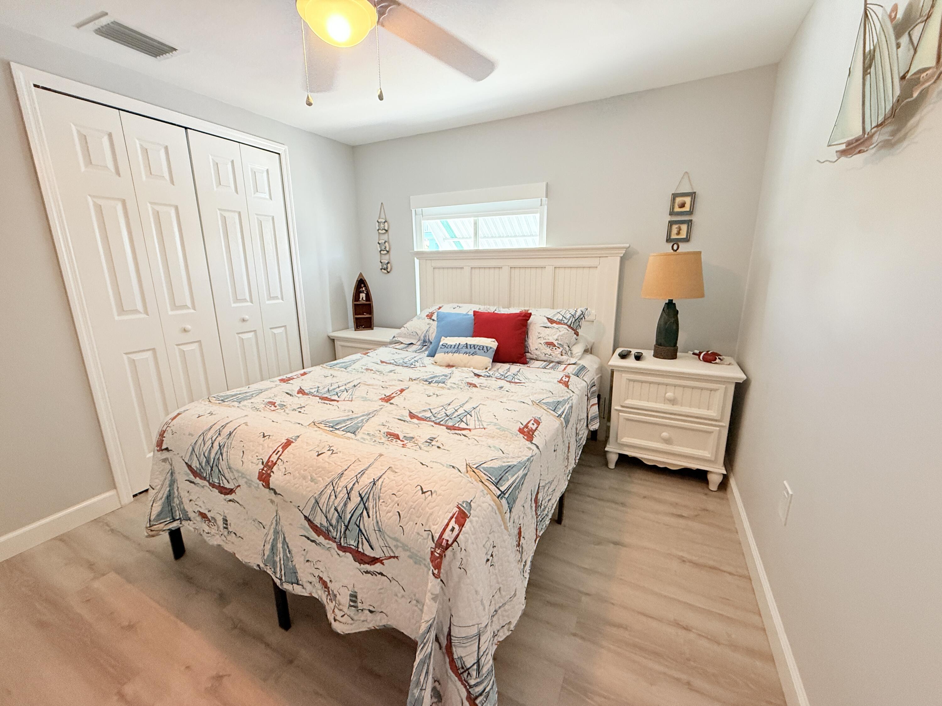 505 Oldsmar Lane Key Largo, FL 33037 - Photo 31 of 58 a bedroom with a bed and a chandelier