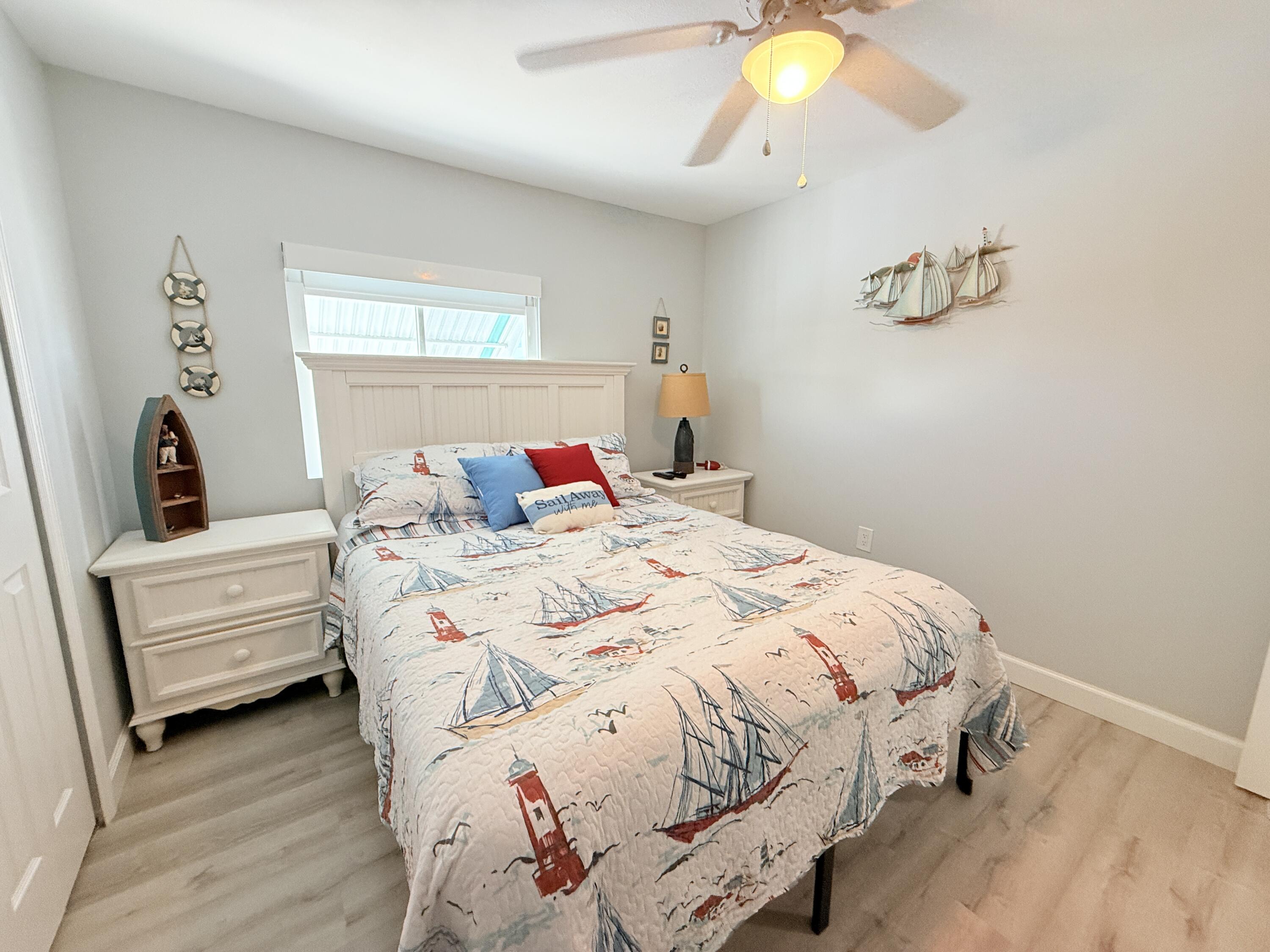 505 Oldsmar Lane Key Largo, FL 33037 - Photo 33 of 61 a bedroom with a bed and a chandelier