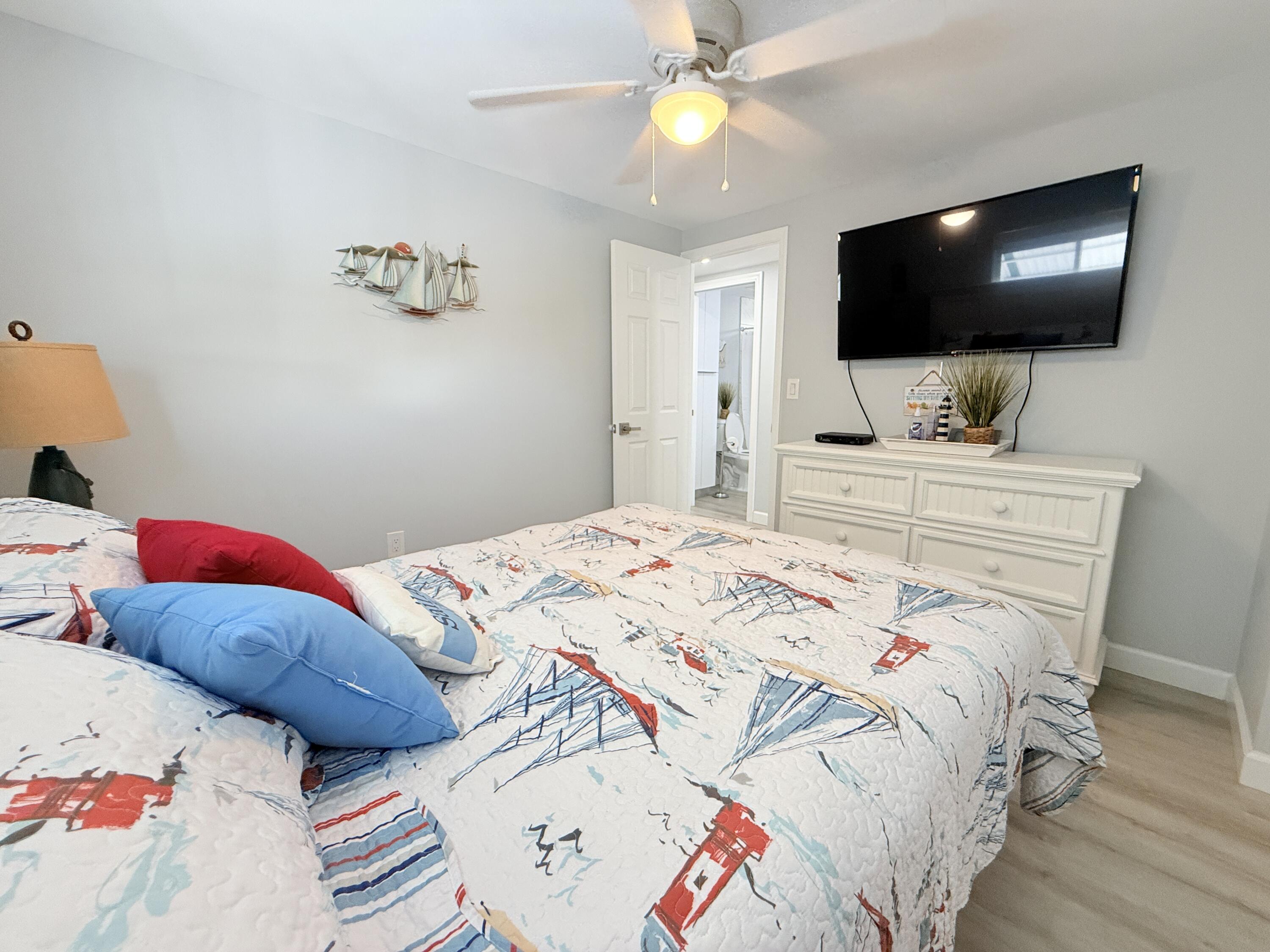 505 Oldsmar Lane Key Largo, FL 33037 - Photo 33 of 58 a bedroom with a bed and a flat screen tv