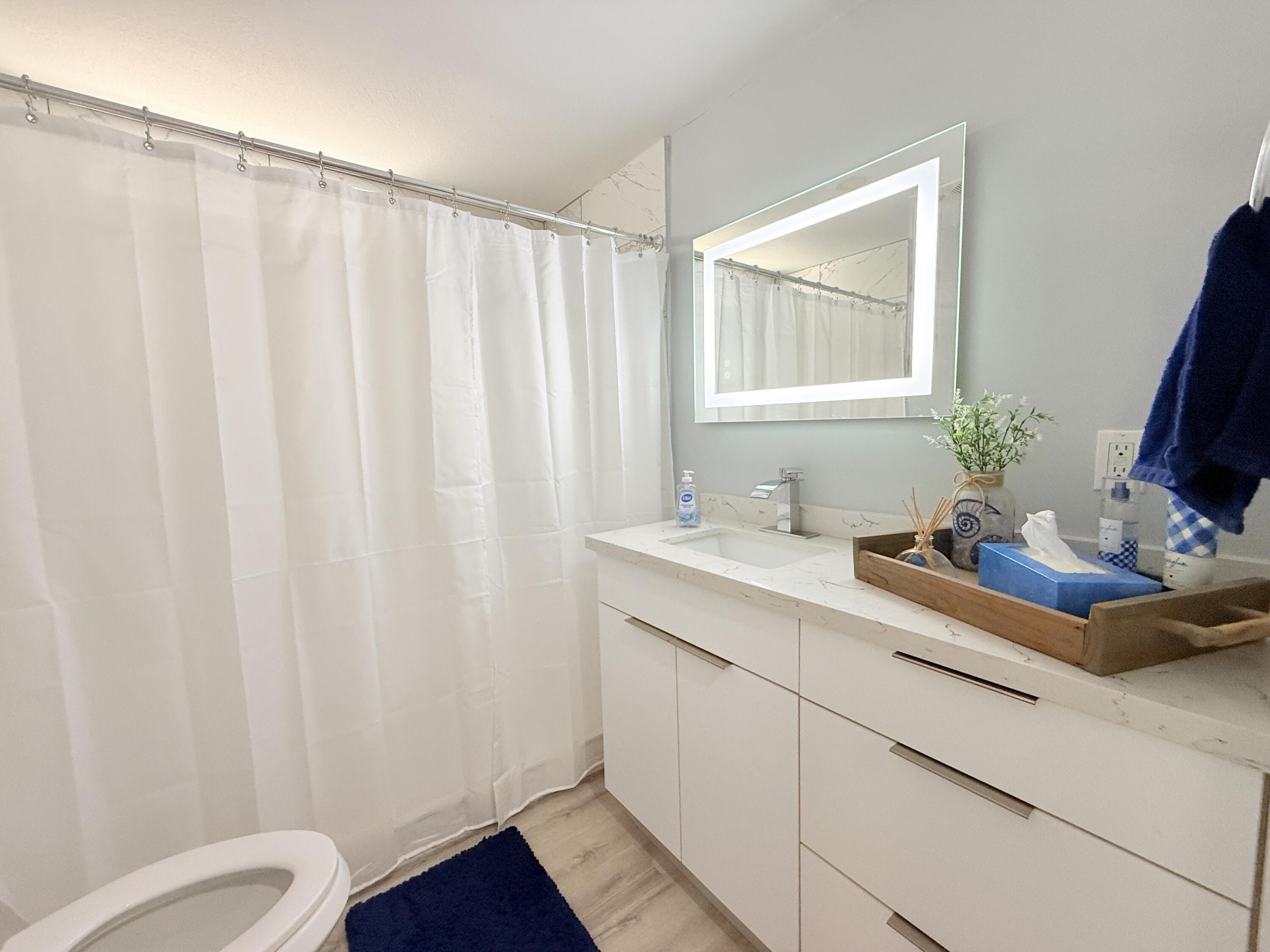 505 Oldsmar Lane Key Largo, FL 33037 - Photo 34 of 58 a bathroom with a sink mirror vanity and toilet