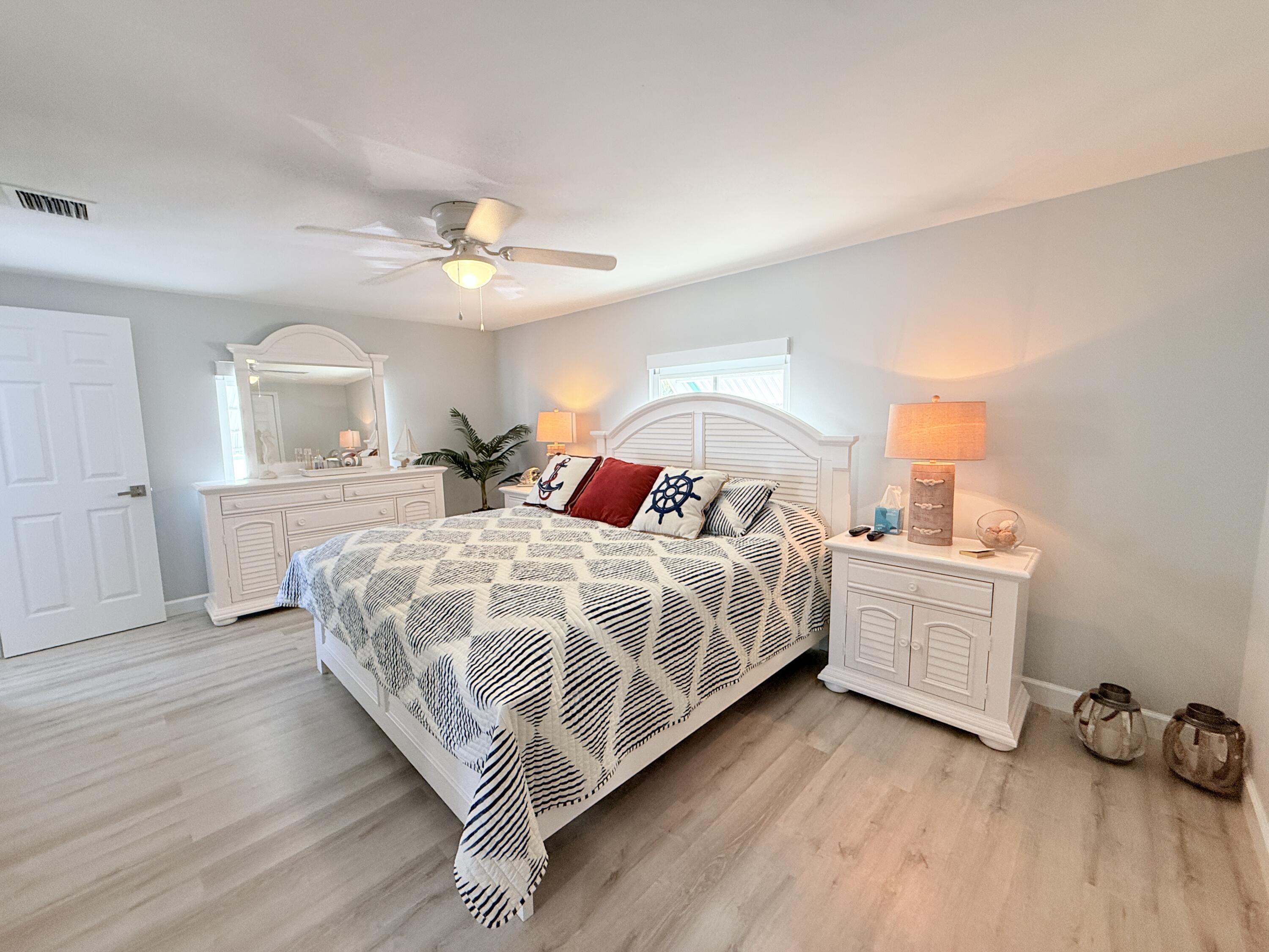 505 Oldsmar Lane Key Largo, FL 33037 - Photo 35 of 58 a bedroom with a bed and a cabinets