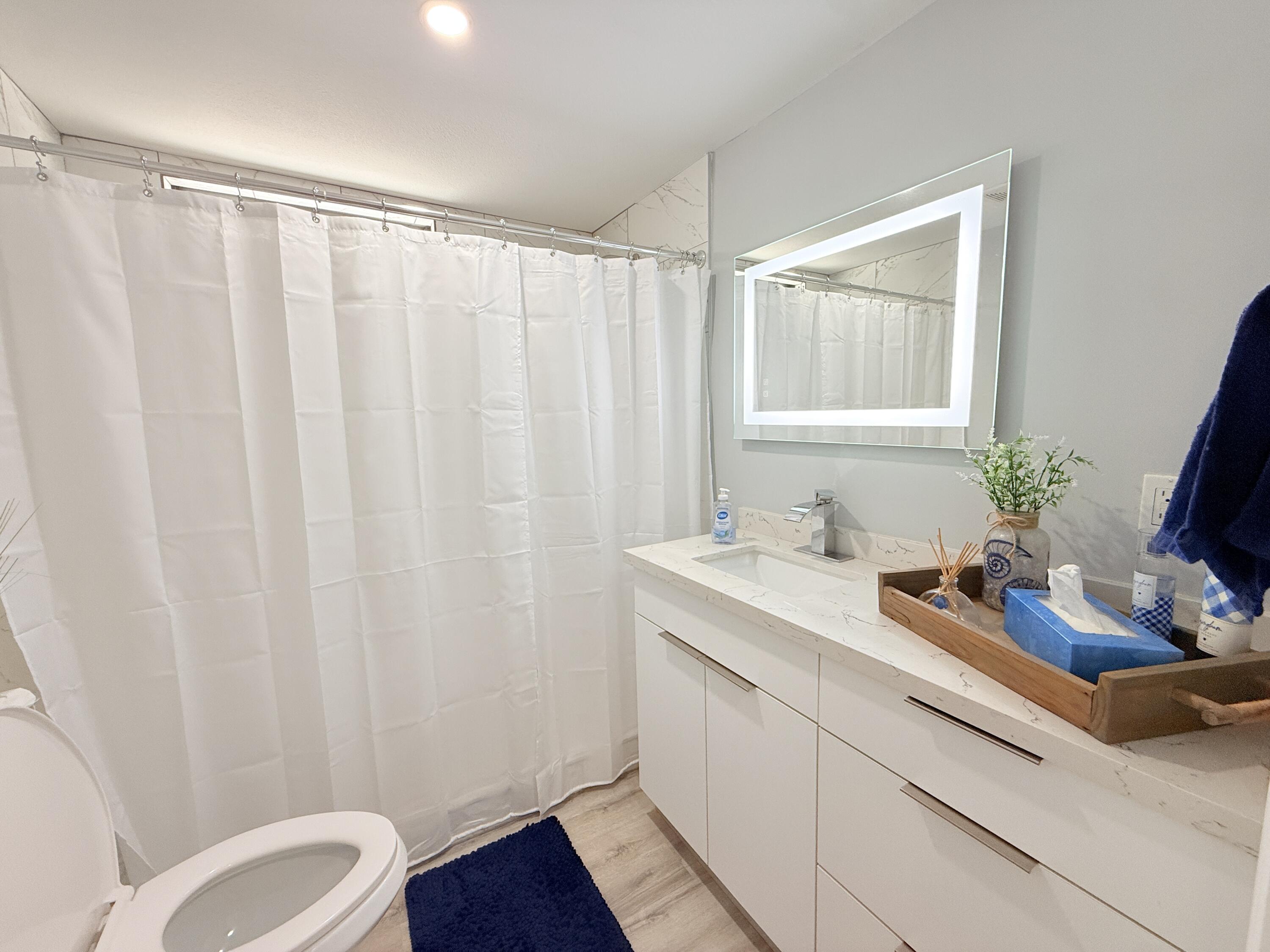 505 Oldsmar Lane Key Largo, FL 33037 - Photo 36 of 61 a bathroom with a granite countertop sink and a mirror