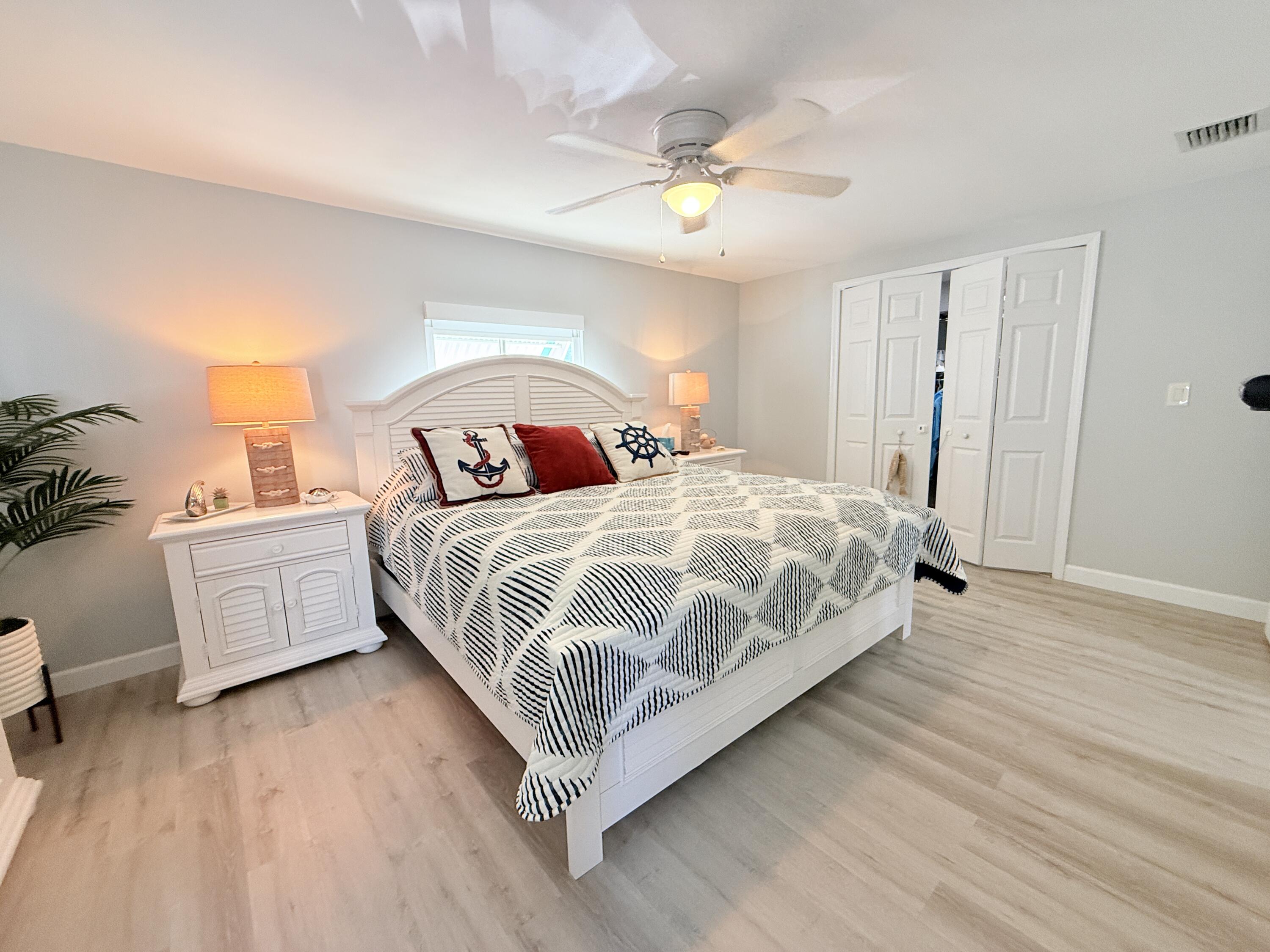 505 Oldsmar Lane Key Largo, FL 33037 - Photo 39 of 61 a bedroom with a bed and a chandelier