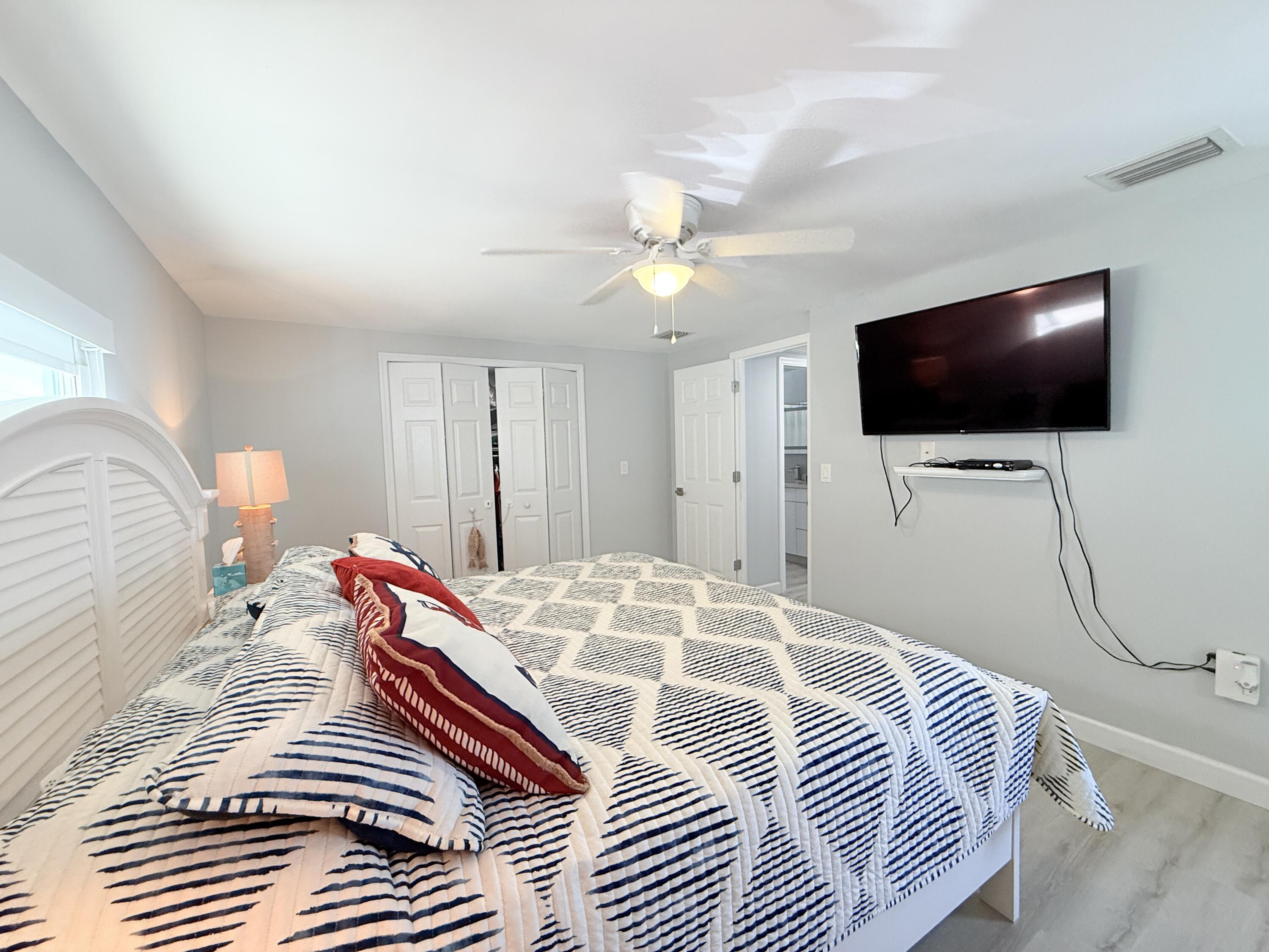 505 Oldsmar Lane Key Largo, FL 33037 - Photo 40 of 61 a bedroom with a bed and a flat screen tv