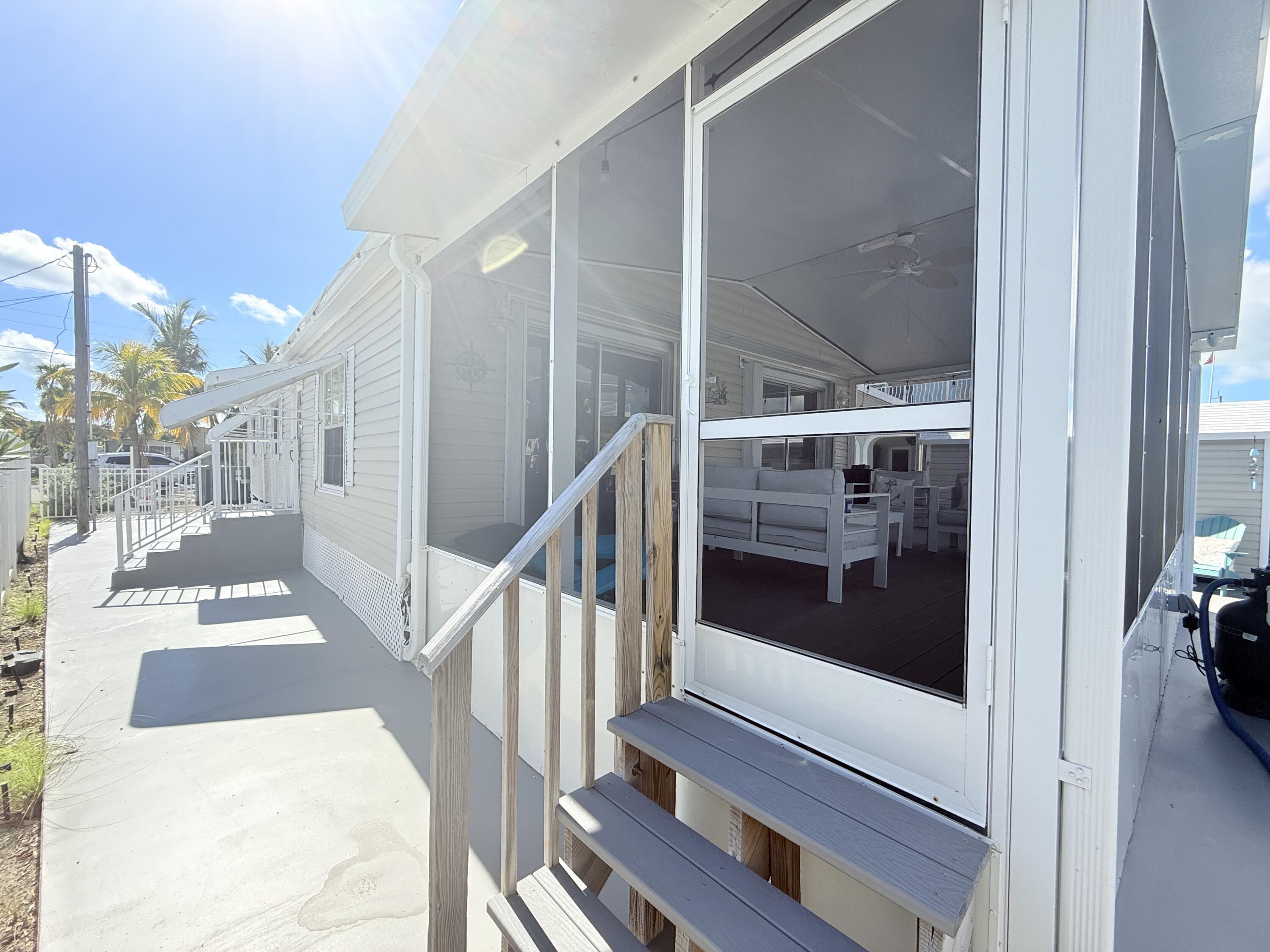 505 Oldsmar Lane Key Largo, FL 33037 - Photo 45 of 61 a view of staircase with wooden floor and a floor to ceiling window