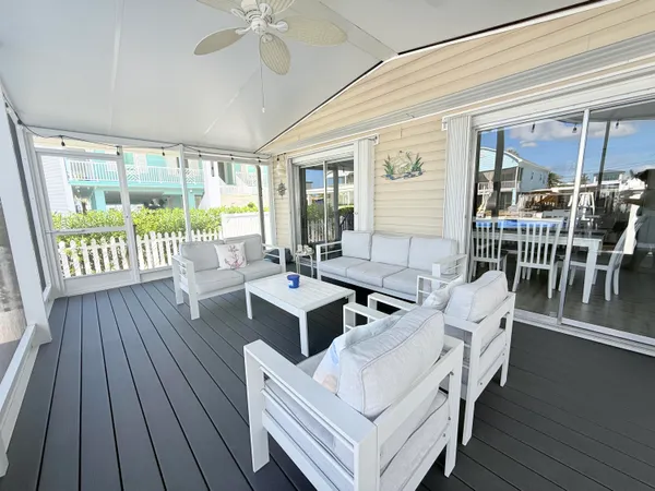 a view of a chairs and table in the balcony