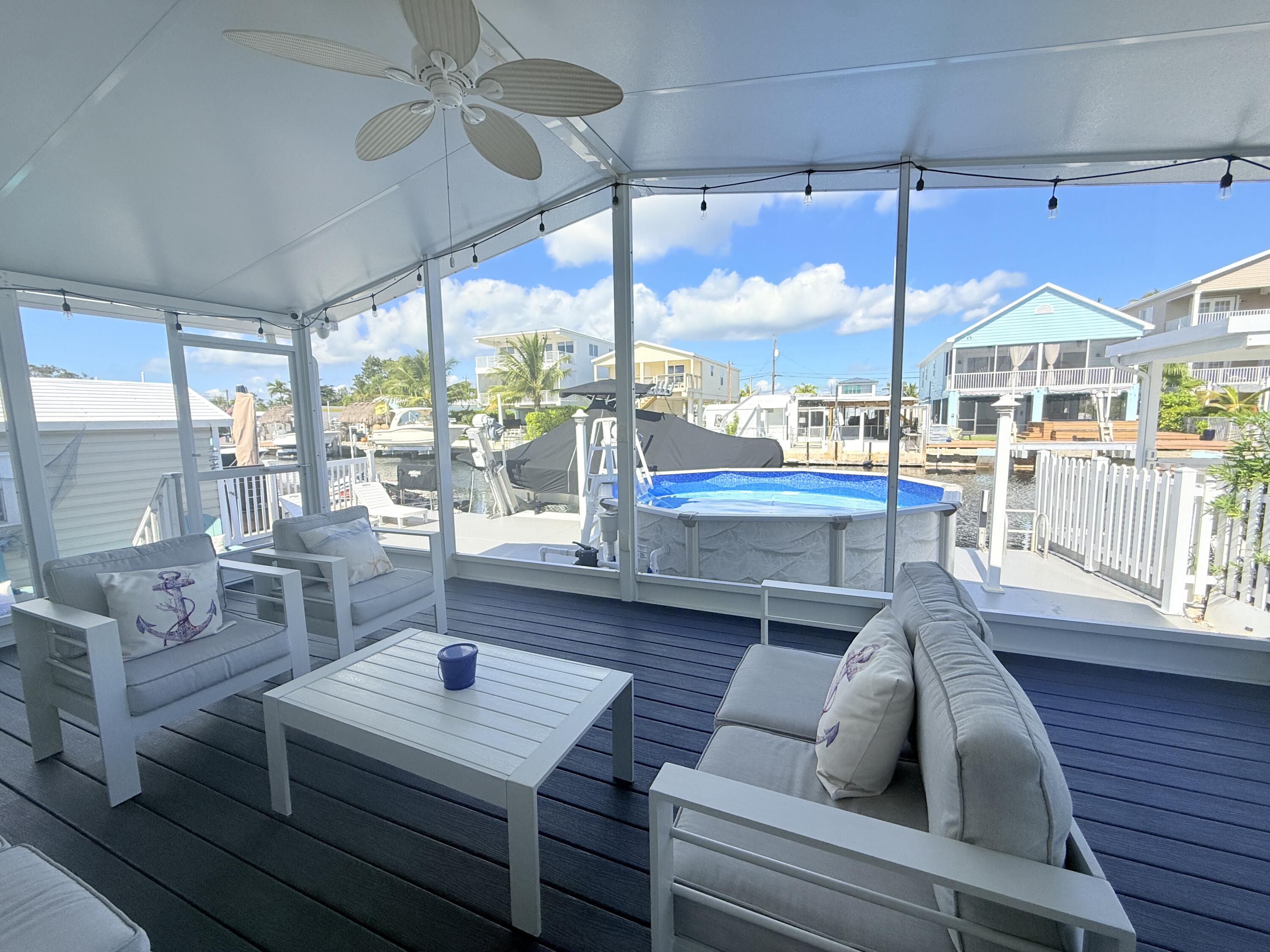 505 Oldsmar Lane Key Largo, FL 33037 - Photo 49 of 61 a living room with furniture a table and a large window