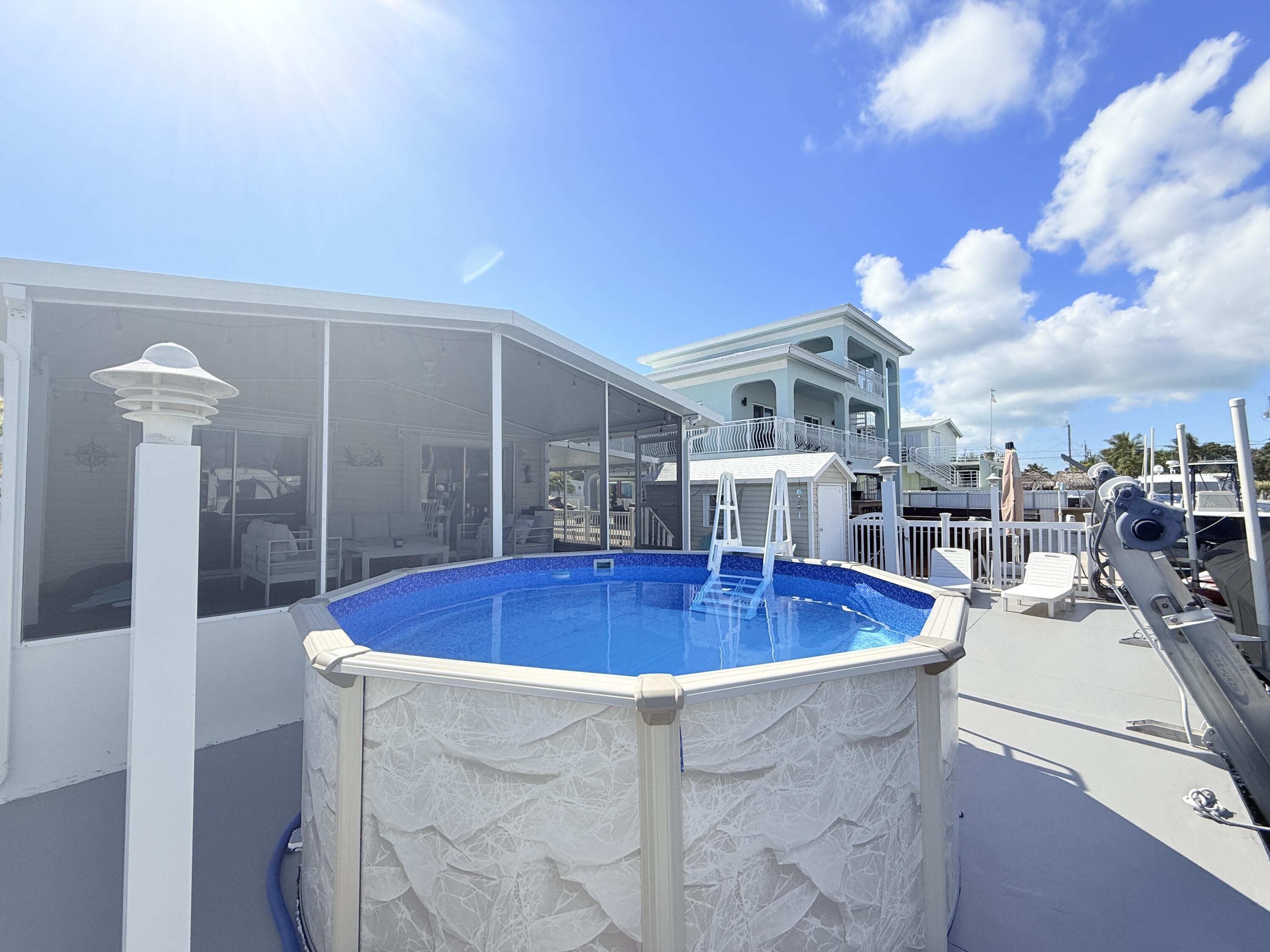 505 Oldsmar Lane Key Largo, FL 33037 - Photo 51 of 58 a view of a swimming pool with outdoor seating