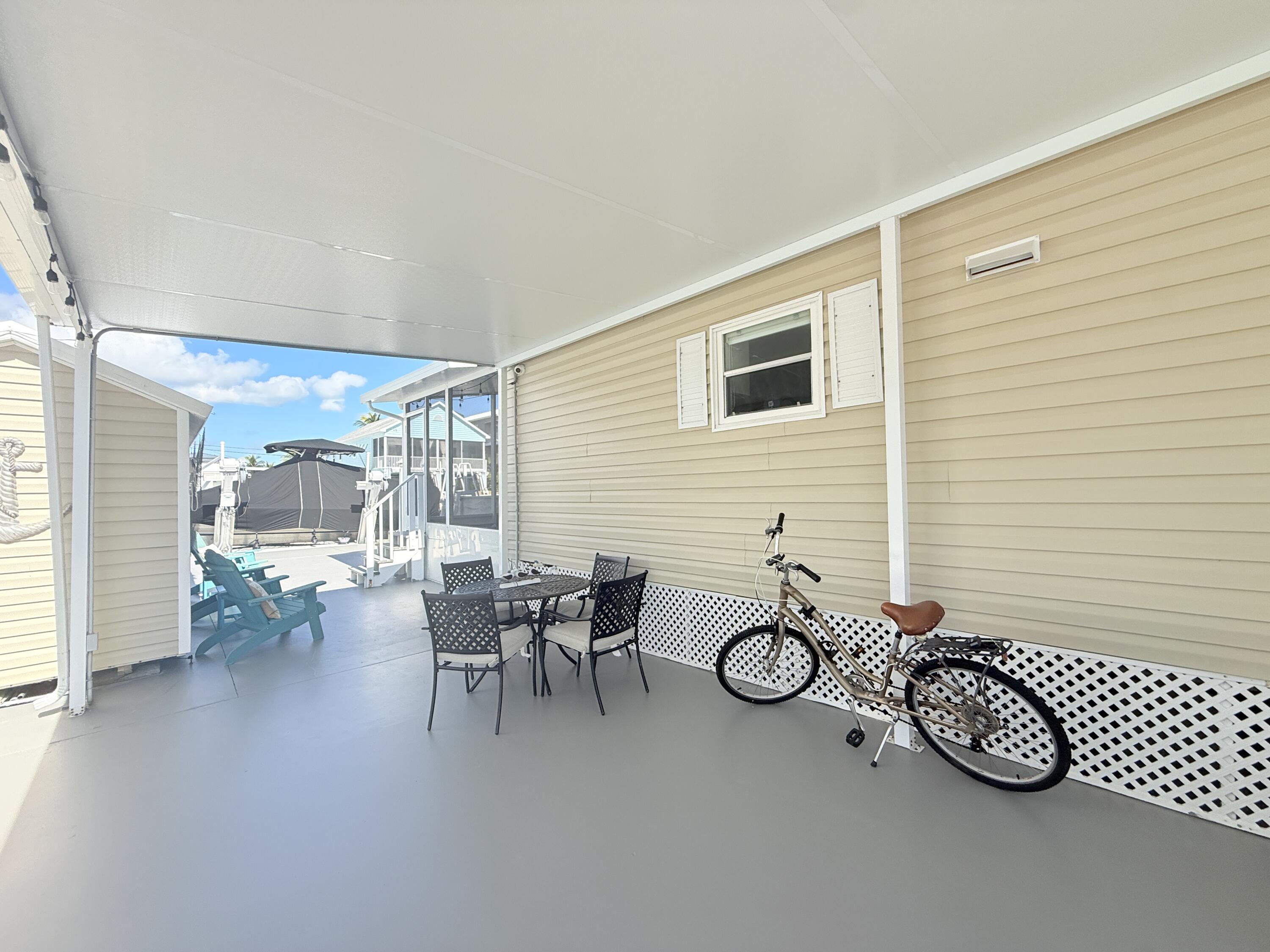 505 Oldsmar Lane Key Largo, FL 33037 - Photo 55 of 61 a view of a patio with table and chairs