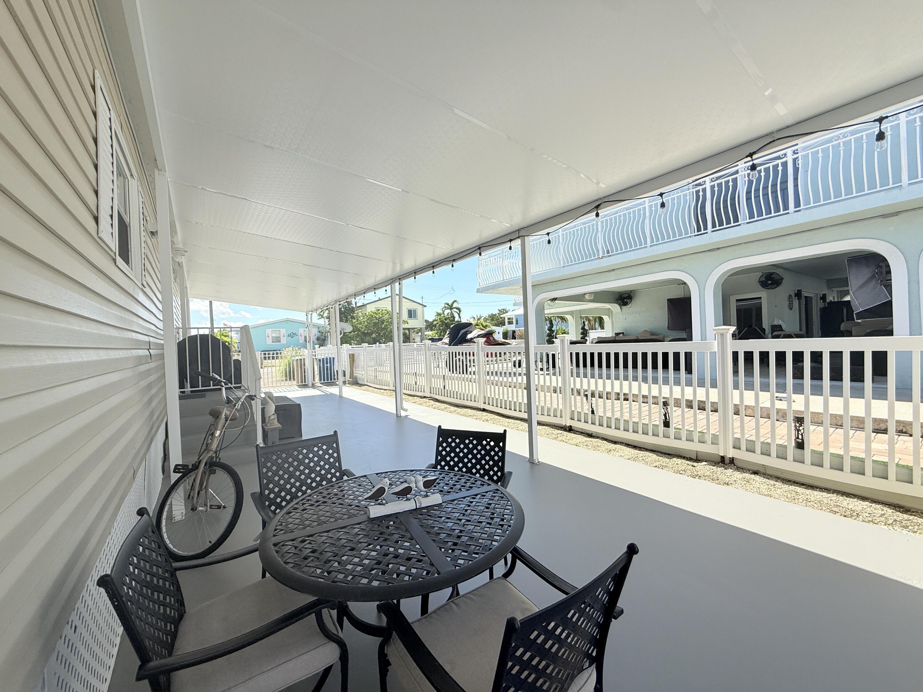 505 Oldsmar Lane Key Largo, FL 33037 - Photo 58 of 61 a view of a balcony dining area with furniture