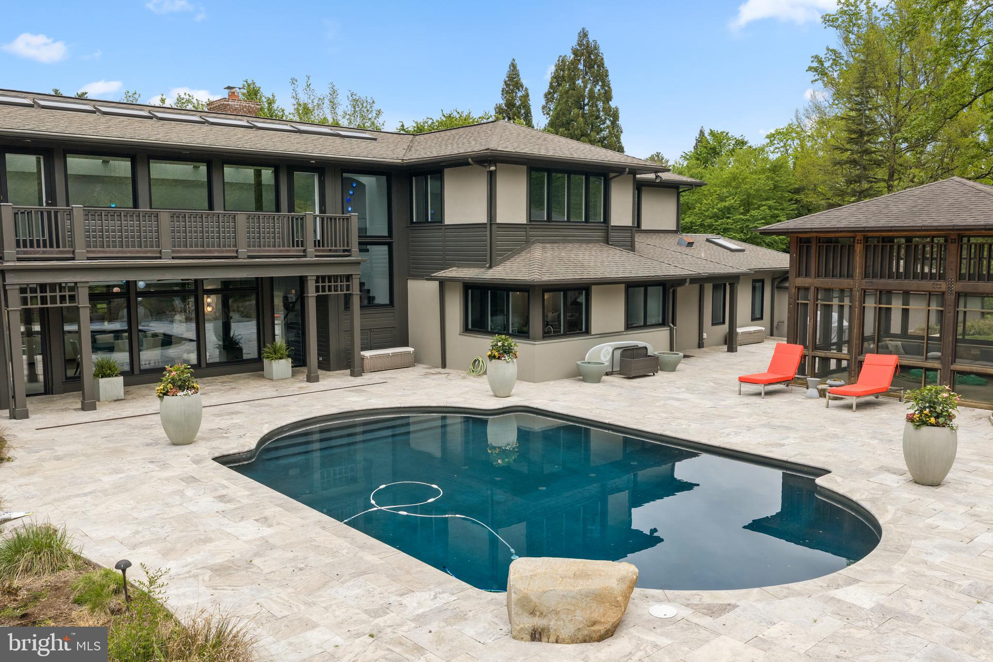 850 Lesley Road Villanova, PA 19085 - Photo 36 of 37 a view of a house with pool and chairs under an umbrella