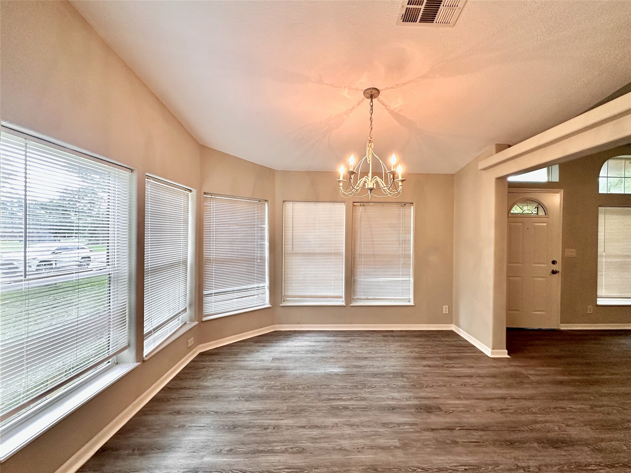 202 Main Street Fresno, TX 77545 - Photo 10 of 26 a view of an empty room with wooden floor and a window