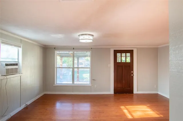 an empty room with windows and closet