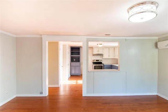 a view of a kitchen with wooden floor