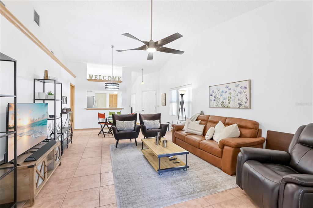 4537 South Lockwood Ridge Road Sarasota, FL 34231 - Photo 7 of 22 a living room with furniture and a flat screen tv