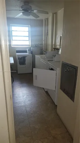 a view of building with cars parked in front of it