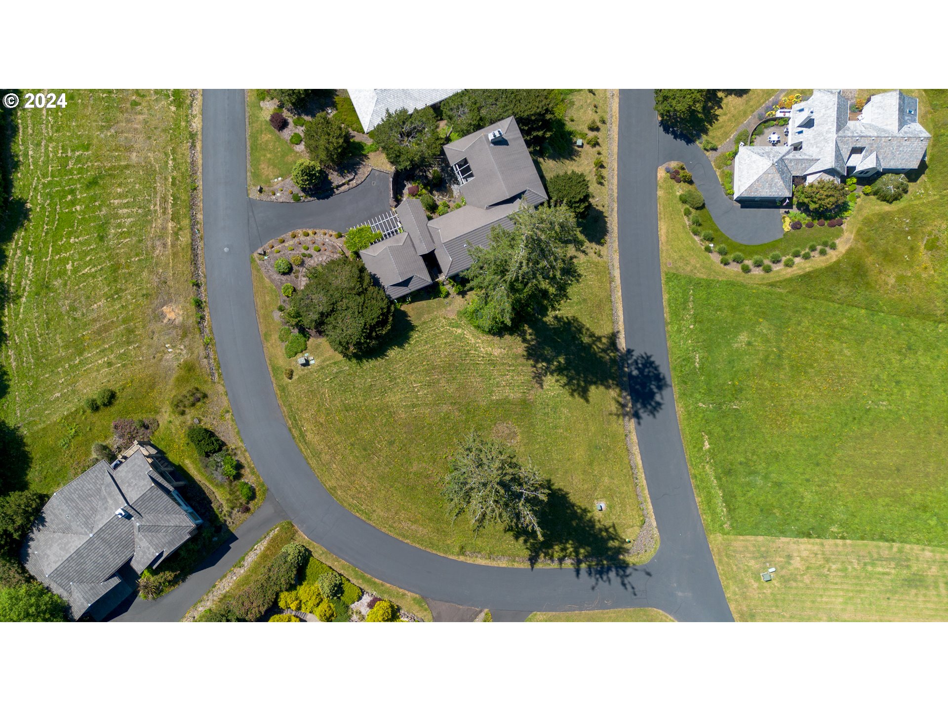 Braeridge Drive, Unit 10 Nehalem, OR 97131 - Photo 3 of 15 an aerial view of a house with a swimming pool