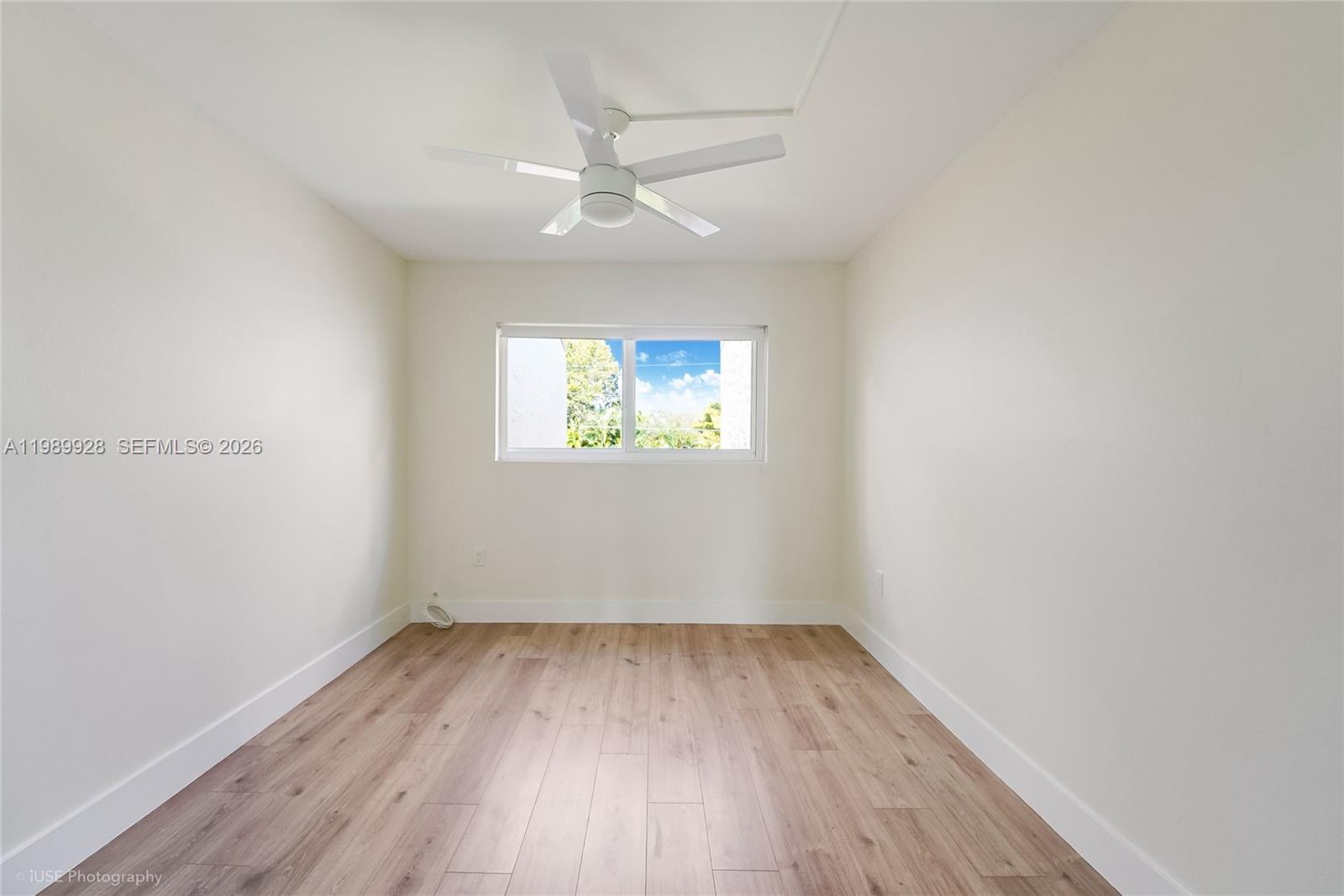 9023 Northeast 4th Avenue Road, Unit 9023 Miami Shores, FL 33138 - Photo 14 of 15 wooden floor in an empty room with a window