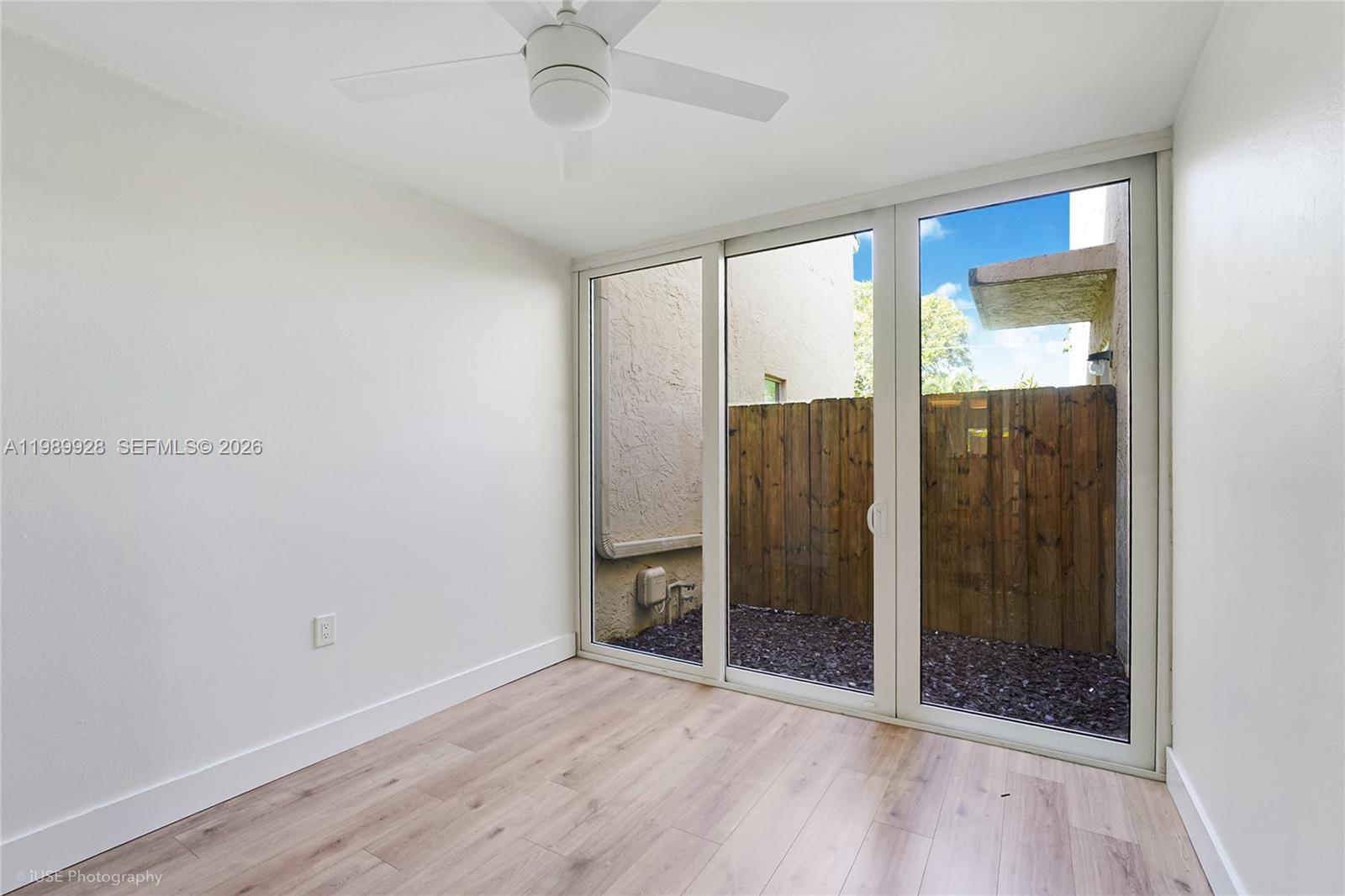 9023 Northeast 4th Avenue Road, Unit 9023 Miami Shores, FL 33138 - Photo 15 of 15 a view of an empty room with wooden floor and a bathroom