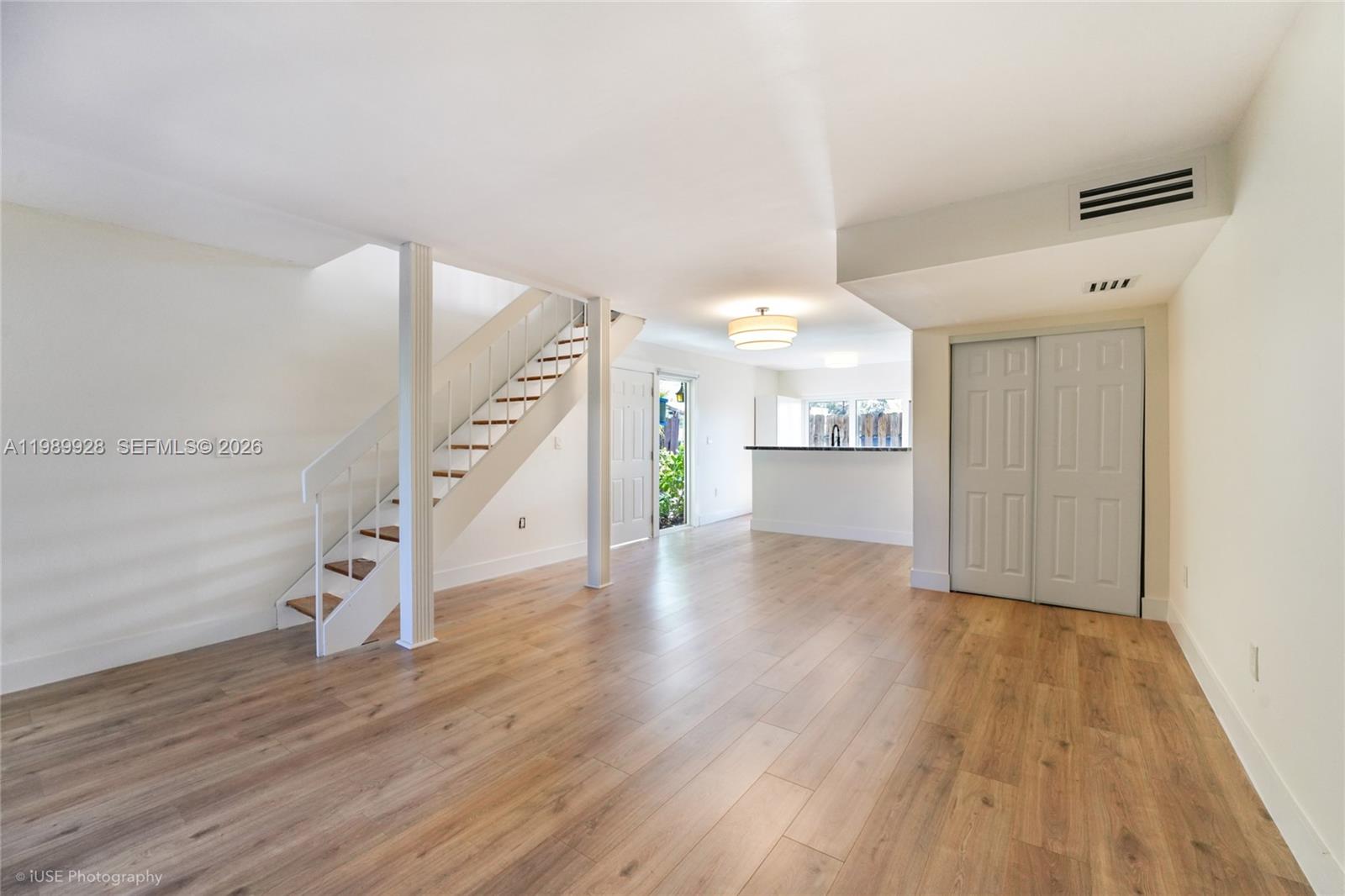 9023 Northeast 4th Avenue Road, Unit 9023 Miami Shores, FL 33138 - Photo 2 of 15 a view of a kitchen with wooden floor and staircase