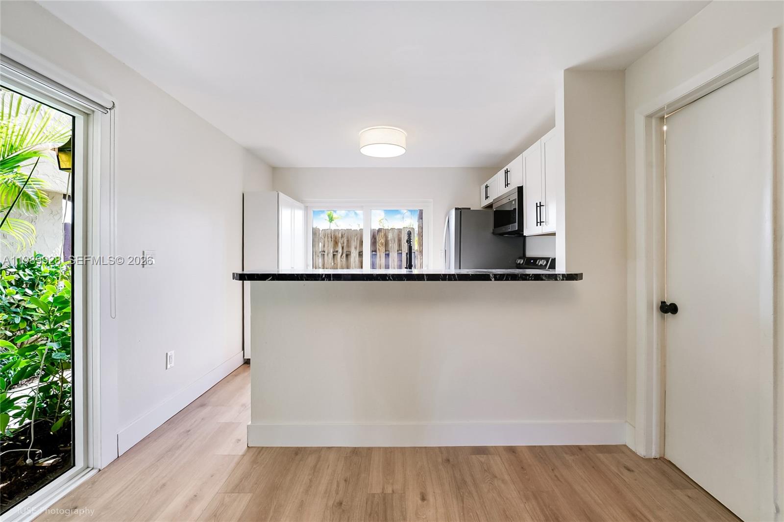 9023 Northeast 4th Avenue Road, Unit 9023 Miami Shores, FL 33138 - Photo 3 of 15 a view of a kitchen with a sink and a window