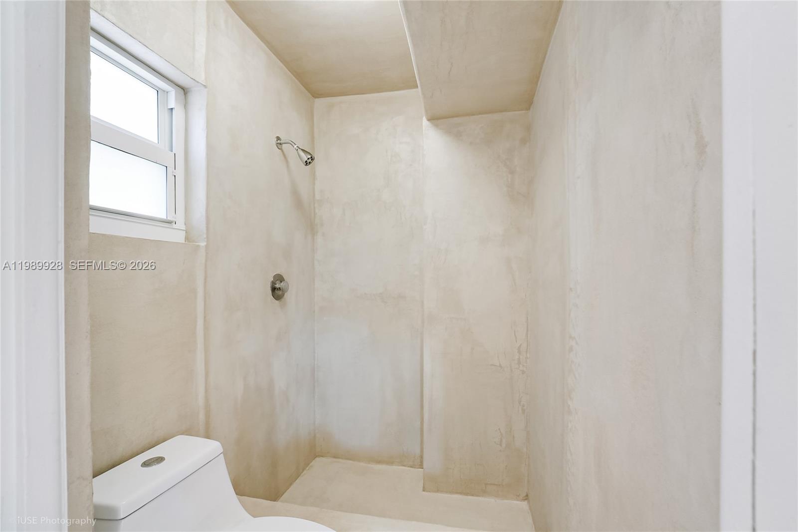 9023 Northeast 4th Avenue Road, Unit 9023 Miami Shores, FL 33138 - Photo 8 of 15 a bathroom with a shower and a toilet