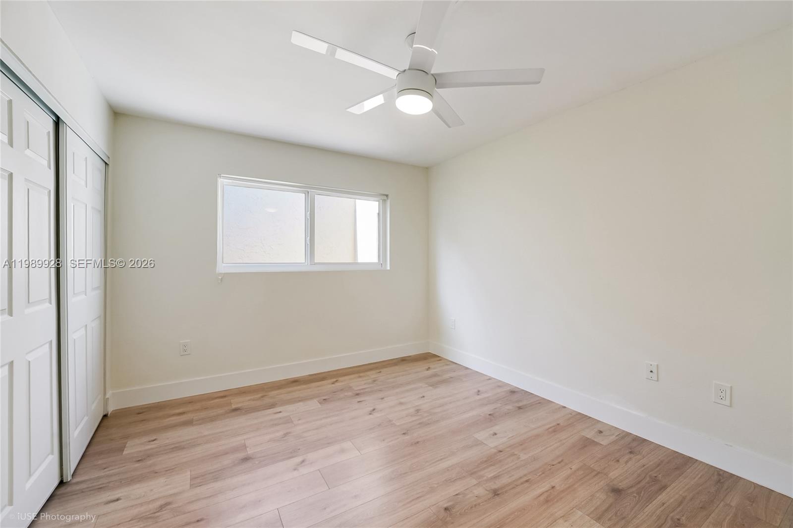 9023 Northeast 4th Avenue Road, Unit 9023 Miami Shores, FL 33138 - Photo 10 of 15 an empty room with wooden floor and windows