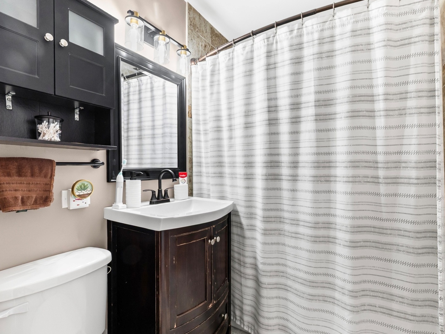 9N564 Flora Drive Elgin, IL 60123 - Photo 11 of 17 a bathroom with a sink a toilet and shower curtain