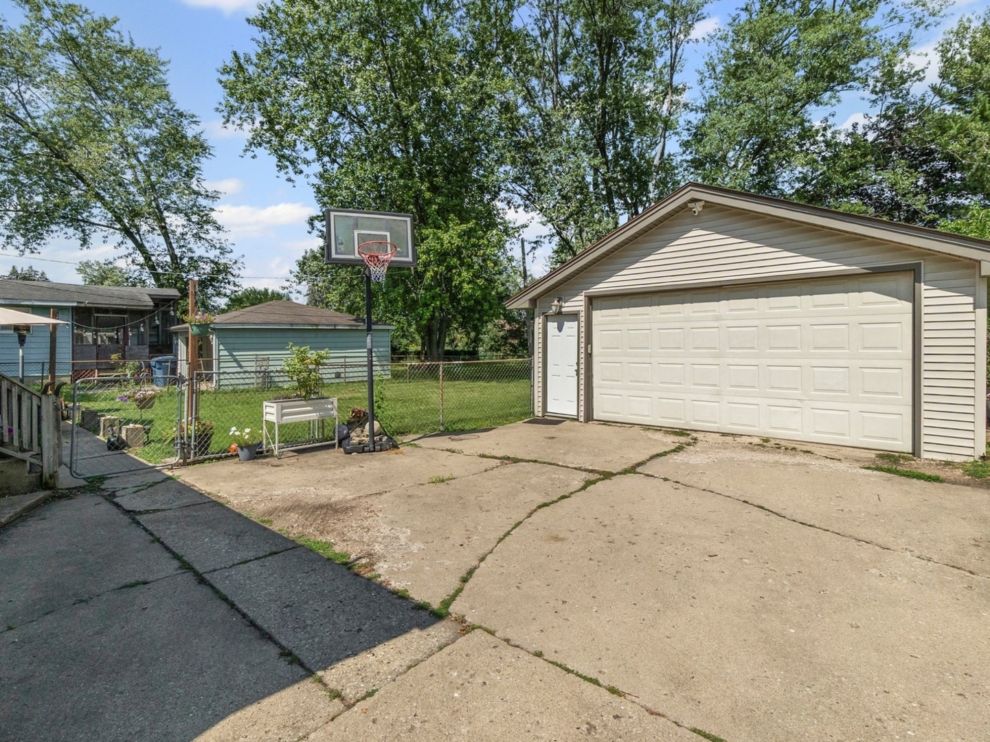 9N564 Flora Drive Elgin, IL 60123 - Photo 16 of 17 a view of a house with a yard and potted plants