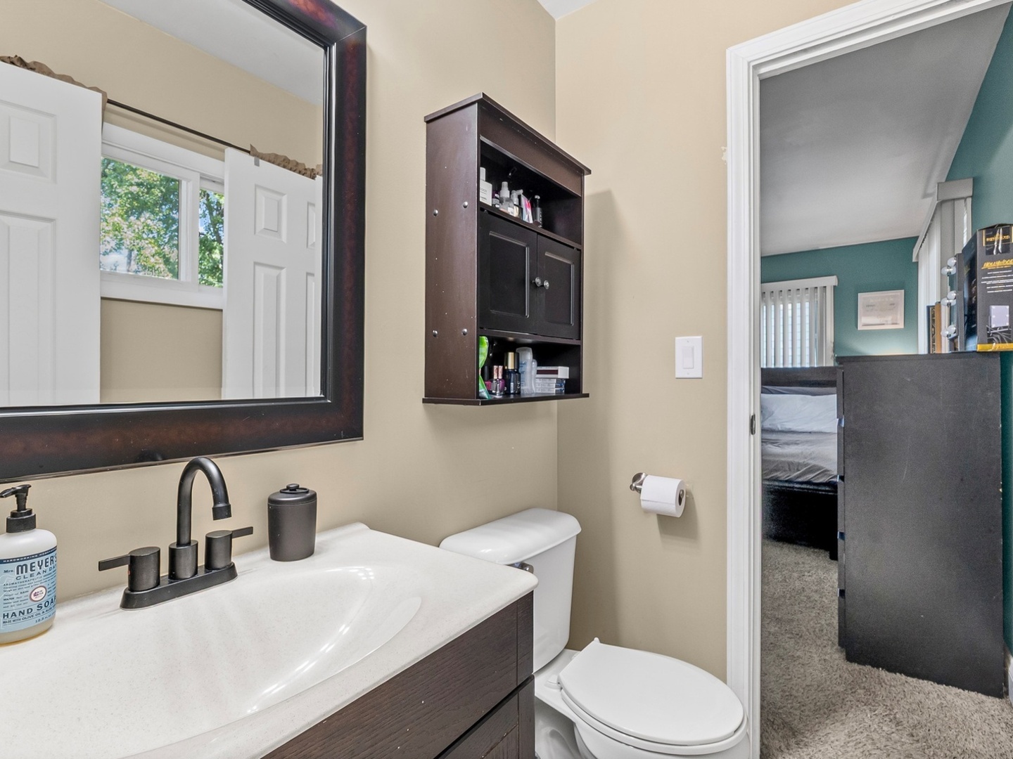 9N564 Flora Drive Elgin, IL 60123 - Photo 8 of 17 a bathroom with a sink a toilet and mirror