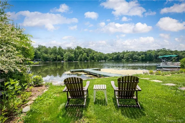 a view of a lake with table and chairs