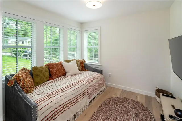 a bathroom with a granite countertop sink a toilet a mirror and shower