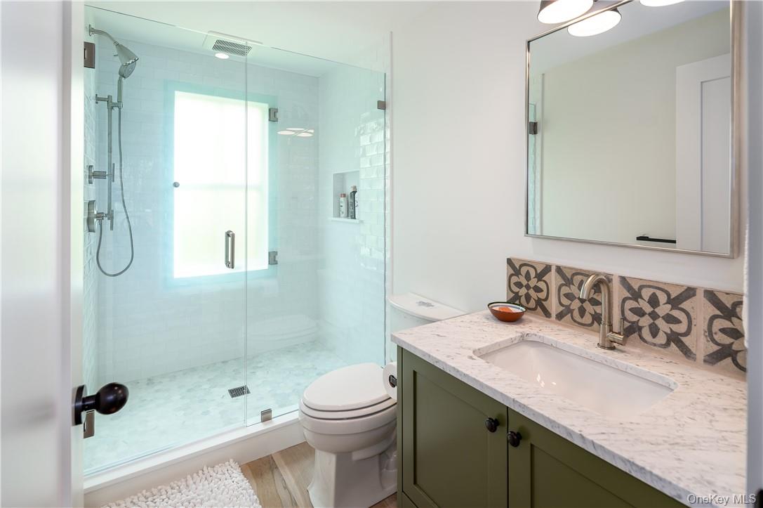24 Cove Road South Salem, NY 10590 - Photo 15 of 26 a bathroom with a granite countertop sink a toilet a mirror and shower