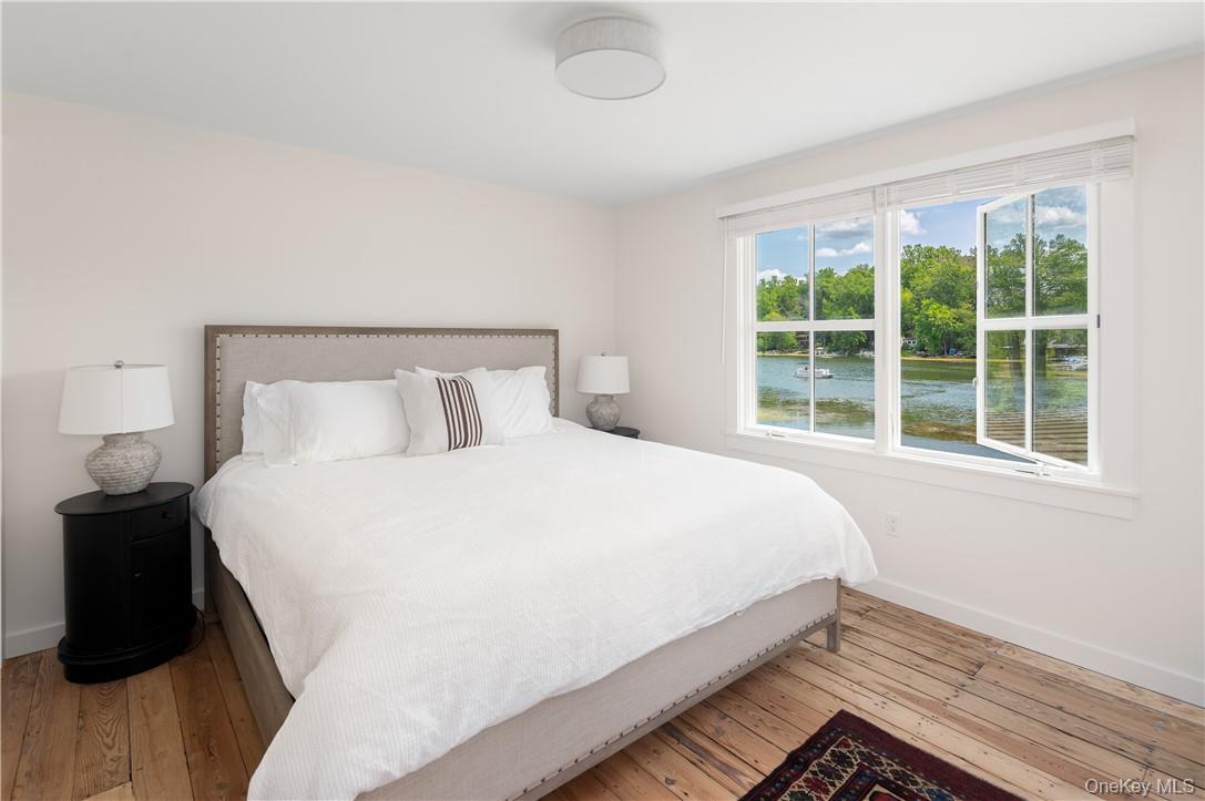24 Cove Road South Salem, NY 10590 - Photo 20 of 26 a large bed sitting in a bedroom next to a window