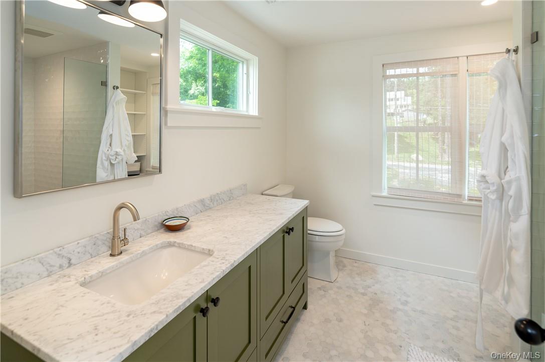 24 Cove Road South Salem, NY 10590 - Photo 21 of 26 a bathroom with a granite countertop sink a toilet and a window
