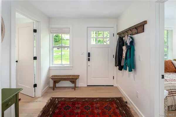 a view of walk in closet with clothes and a rug