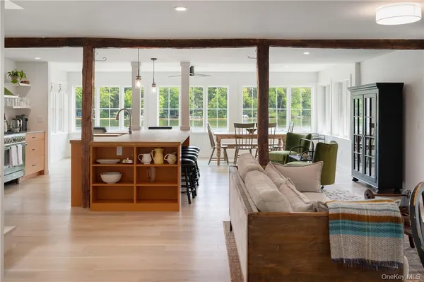 a living room with fireplace furniture and a large window