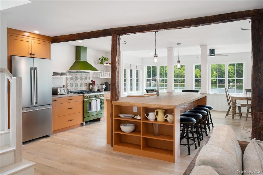 24 Cove Road South Salem, NY 10590 - Photo 6 of 26 a kitchen with stainless steel appliances granite countertop a stove a refrigerator a sink a dining table and chairs with wooden floor