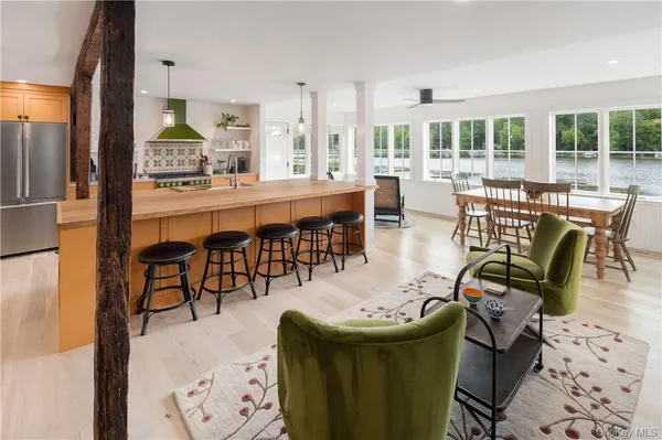 a dining room with furniture a chandelier and wooden floor