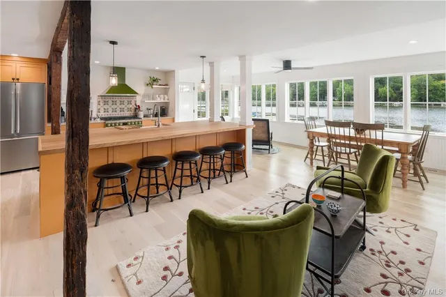 a dining room with furniture a chandelier and wooden floor