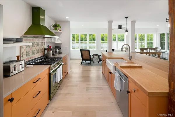 a kitchen with stainless steel appliances a sink stove and cabinets